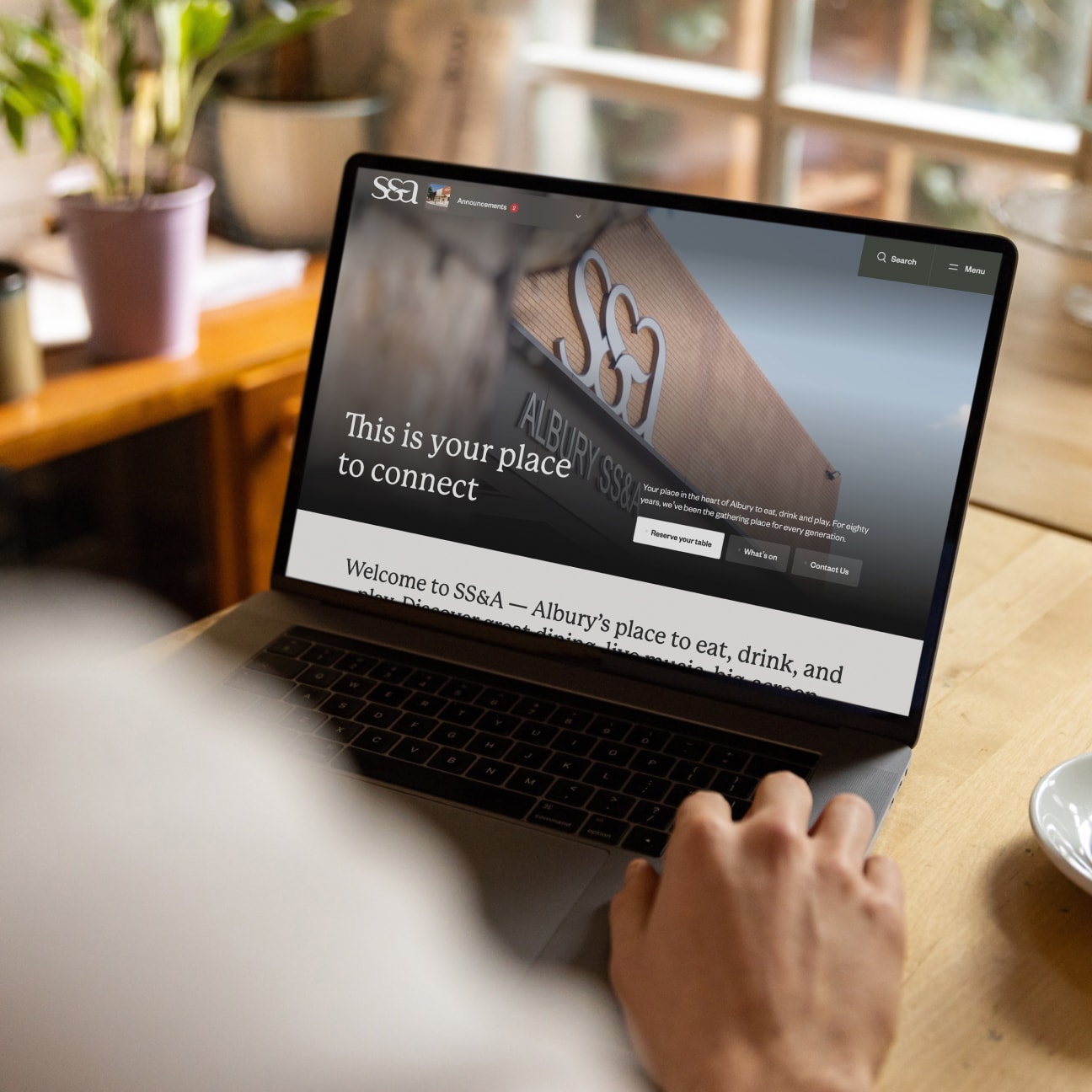 SS&A Club homepage shown on a laptop mockup
